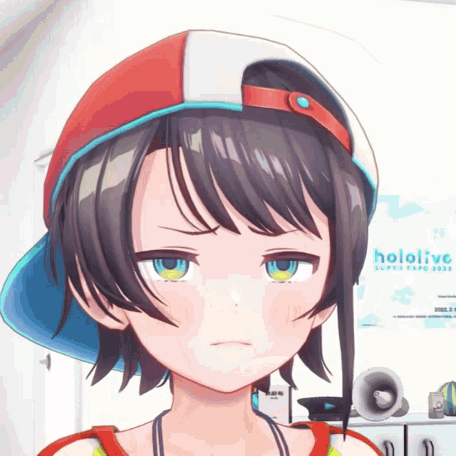 a girl with a hat and a poster that says hololive in the background