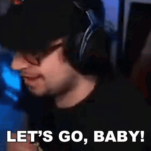 a man wearing headphones and glasses is saying let 's go baby .