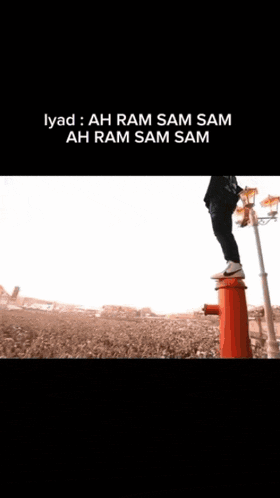 a crowd of people are gathered in front of a stage that says ah ram sam sam on it