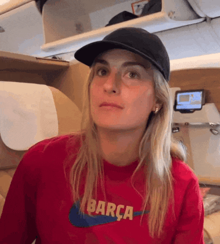 a woman wearing a red shirt that says barca