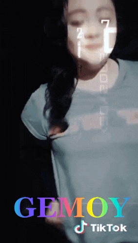 a girl in a blue shirt with the word gemoy on the bottom