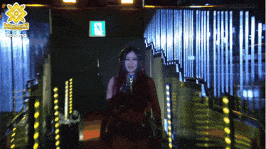 a woman is walking through a hallway with a sign that says ' power ' at the top