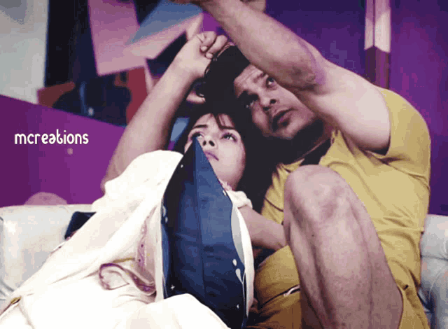 a man and a woman are sitting on a couch with the words mccreations written above them