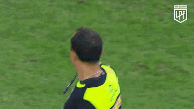 a referee wearing a black and yellow fifa referee jersey