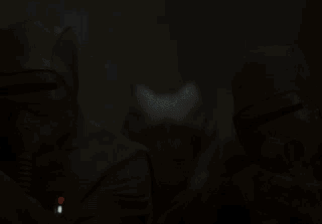 a woman with a mask on holds a light saber in front of her face