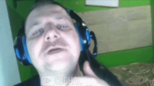 a man wearing headphones with the word kichal on the bottom left