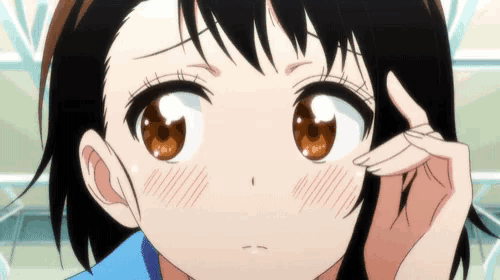 a close up of a girl 's face with brown eyes