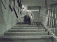 a person is standing on a set of stairs with their legs crossed .