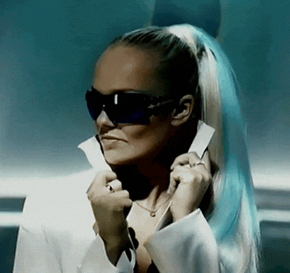 a woman with blue hair wearing sunglasses and a white jacket