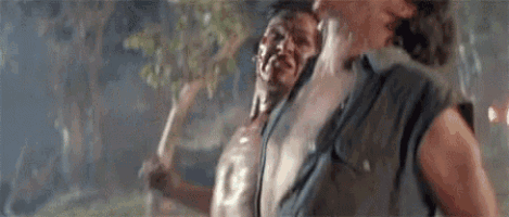 a couple of men are standing next to each other in the rain .