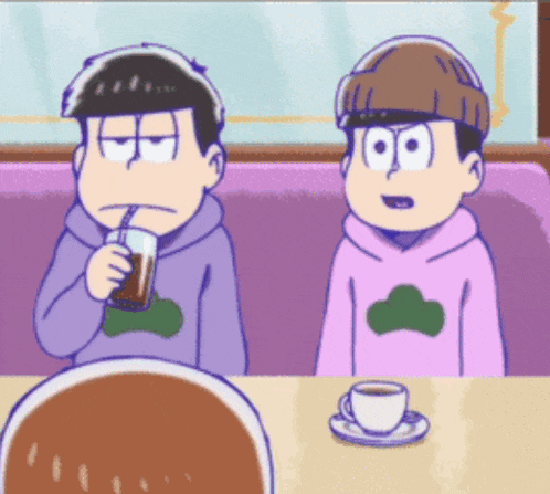 two cartoon characters are sitting at a table with a cup of coffee