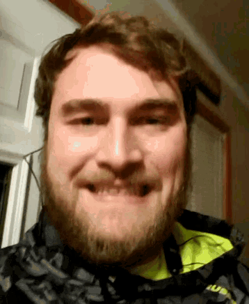 a man with a beard wearing a jacket that says us