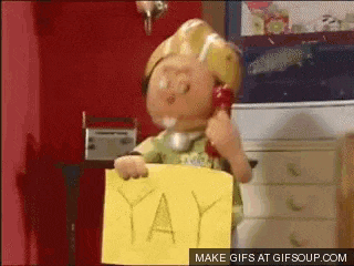 bob the builder is talking on a phone while holding a yellow sign that says yay .