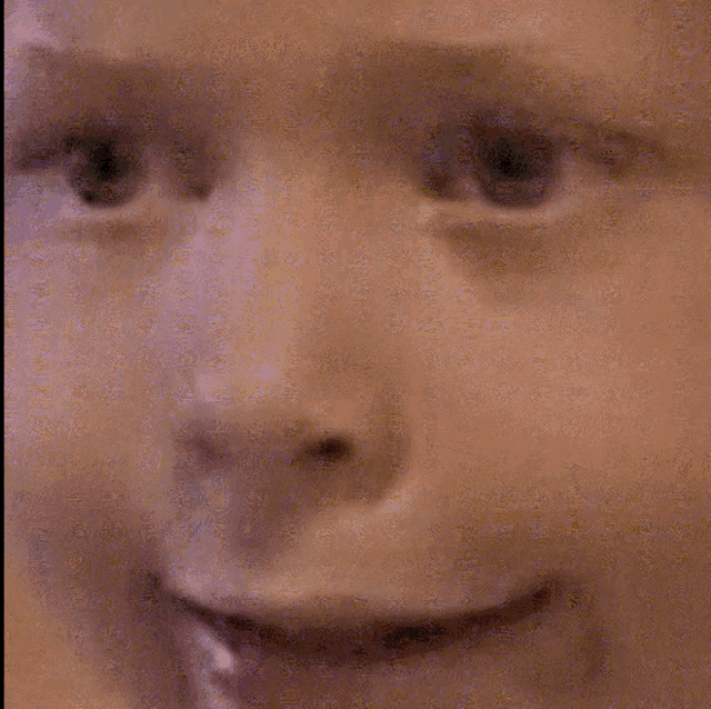 a close up of a person 's face with a smile on their face