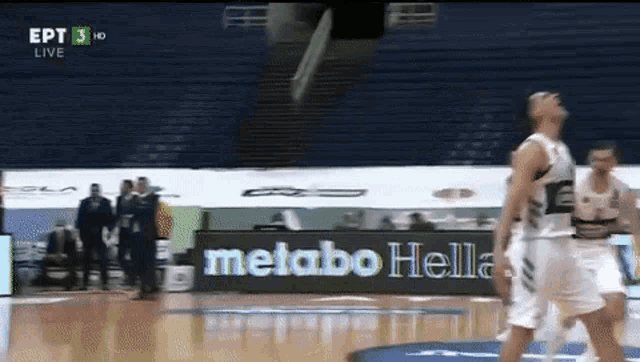 a basketball game is being played in a stadium with an ad for metabo