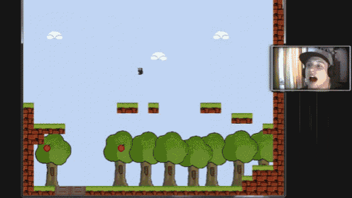 a man is playing a video game with trees and blocks