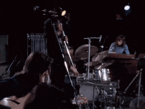 a group of people playing musical instruments on a stage