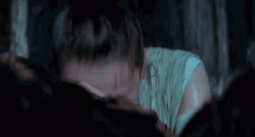 a close up of a woman 's face with tears running down her cheeks .