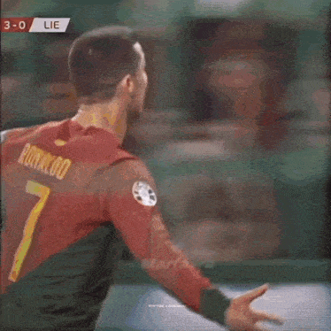 a blurred image of a person jumping in the air with a score of 3-0 behind them .