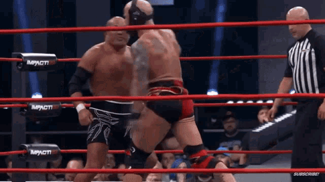two men are wrestling in a ring that says impact on the corner
