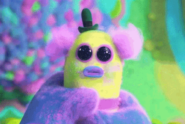 a person is holding a stuffed animal with a top hat on .