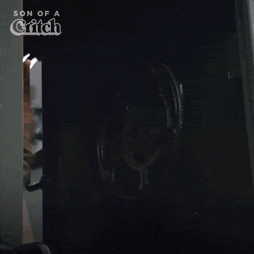 a man standing in a dark room with the words son of a glitch on the bottom