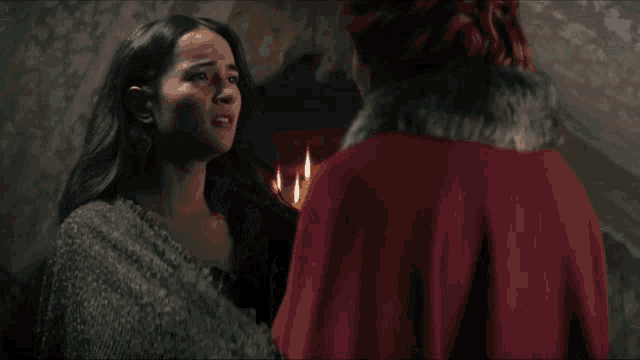 a woman in a fur coat is hugging a young girl