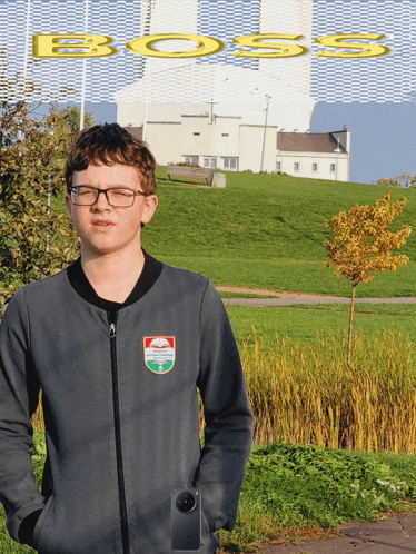 a boy wearing glasses is standing in front of a large building that says boss