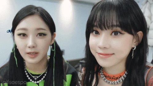 a couple of girls are standing next to each other with the words gifsaespa on the bottom