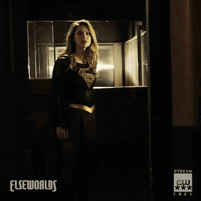 a blurry picture of a person walking down a hallway with the words elseworlds on the bottom
