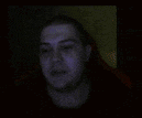 a blurry picture of a man 's face in a dark room