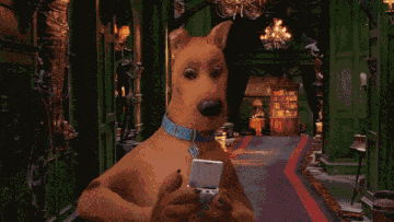 scooby doo is looking at a picture of a man on a screen