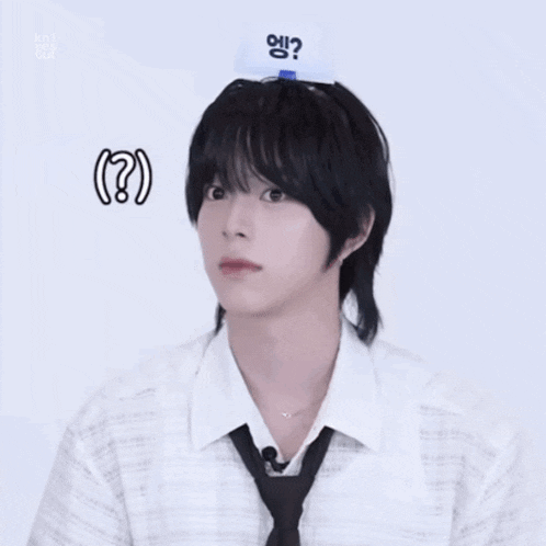 a man wearing a white shirt and a black tie has a white card on his head that says ?
