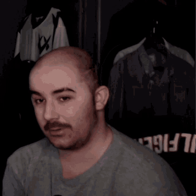 a man wearing a shirt that says ' snickers ' on it