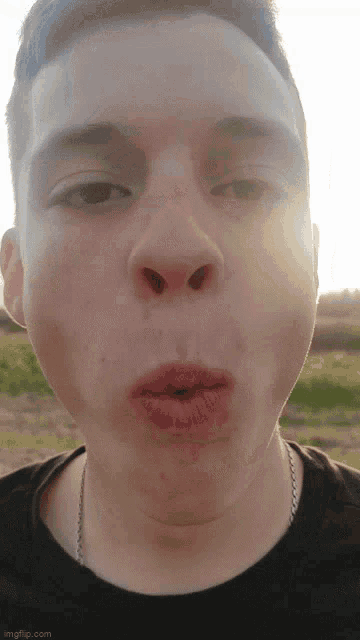 a close up of a young man 's face with his mouth open