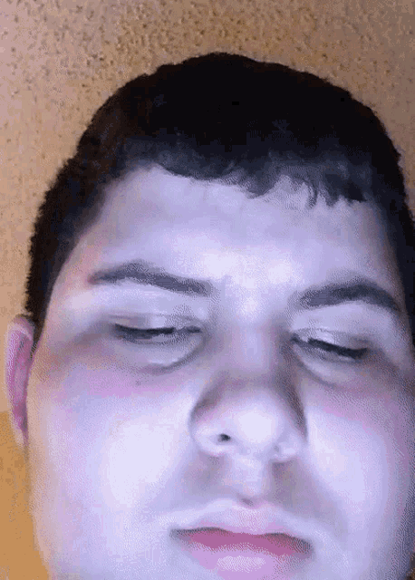 a close up of a man 's face with his eyes closed and his mouth open