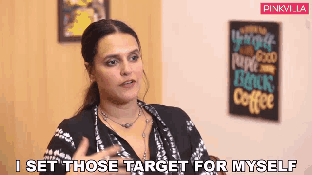 a woman says i set those target for myself in front of a sign that says black coffee