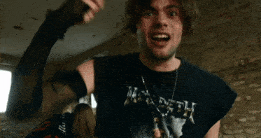 a man is wearing a black shirt that says megadeth
