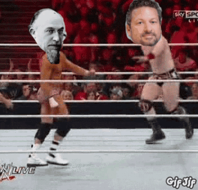 two men in a wrestling ring with their faces cut out and the words gif jif on the bottom right