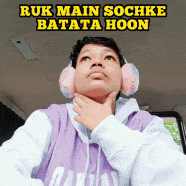 a man wearing ear muffs and a purple shirt with the words ruk main sochke batata hoon written above him