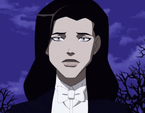a woman in a tuxedo with a bow tie looks sad