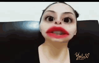 a woman making a funny face with red lipstick and the word yolax on the bottom