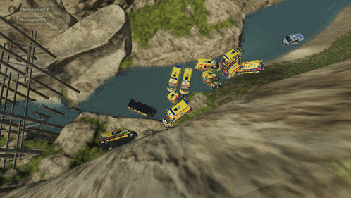 an aerial view of a cliff with a few vehicles on it