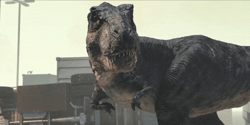 a t-rex is standing in front of a building with a sign that says ' tires ' on it