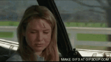 a woman is sitting in a car with a scratch on her forehead .