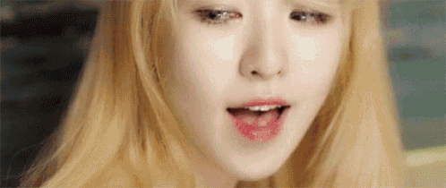 a close up of a woman 's face with blonde hair and red lipstick .