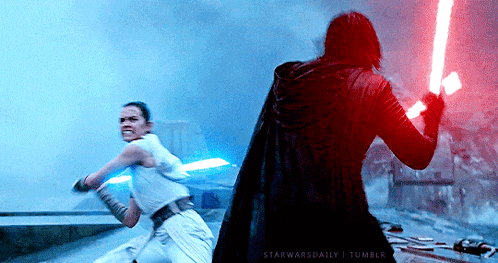 a man and a woman are fighting with lightsabers in a star wars scene