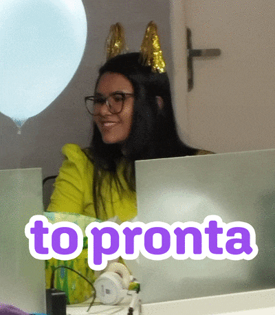 a woman wearing bunny ears sits at a desk in front of a sign that says " to pronta "