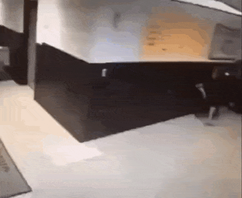 a person is walking down a hallway in a room .