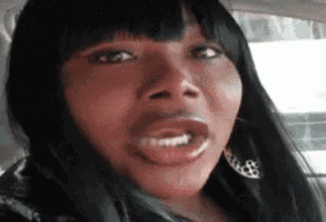 a close up of a woman 's face in a car with her mouth open